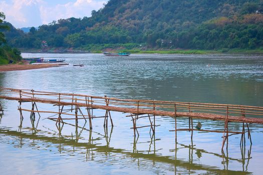 Bamboo bridge over Nam Khan river, in the confluence with Mekong River in Luang, Prabang, Laos.