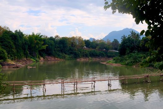 Bamboo bridge over Nam Khan river, in the confluence with Mekong River in Luang Prabang, Laos.