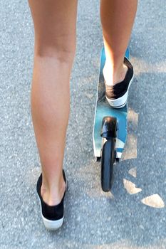 legs of a girl on a scooter, photo of the bottom.
