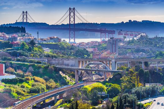 Picturesque panorama of Lisbon with 25th April Bridge and numerous highways, Portugal