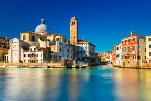 Venice, Italy. Grand Canal and Venetian old architecture against the clear blue sky on the background. Long exposure photography