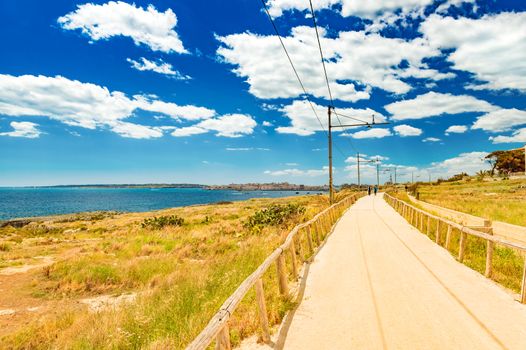 Beautiful road along the coastline of Syracuse. Former railway track, Sicily, Italy