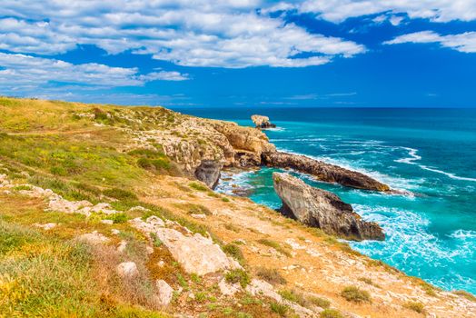 Beautiful landscape with cliffs, turquoise sea water and blue sky, Syracuse, Italy