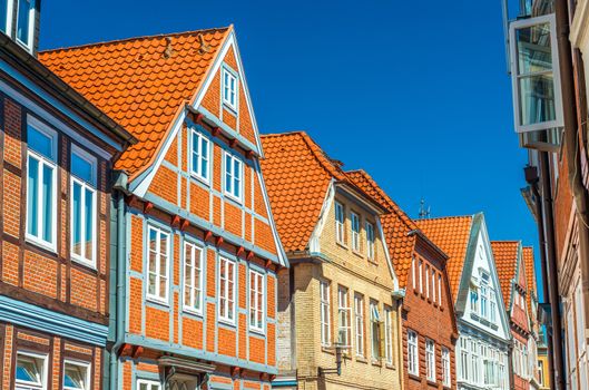 A street with traditional German architecture, half-timbered houses with red roof tiles, Stade, Germany
