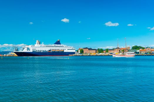 View of the harbor of Oslo with a cruise ship and historical, wooden, sailing ship, Norway