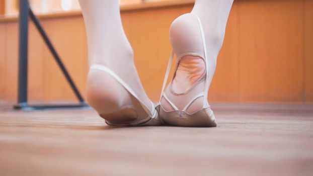 Ballet dancer's feet, training in studio, close up view