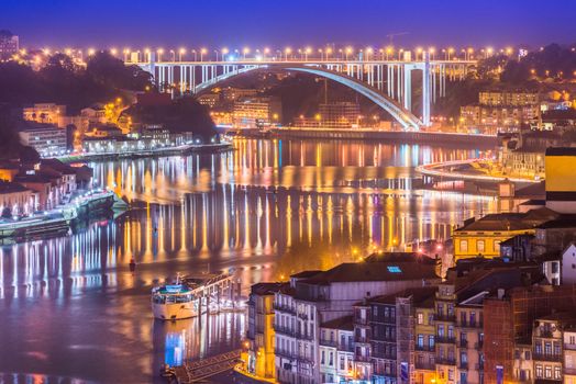 Cityscape of Porto and Arrabida Bridge (Ponte da Arrábida) at night, Valley of The Douro River, Portugal