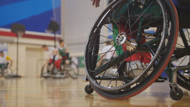 Disabled sportsmen plays wheelchair basketball, wide angle
