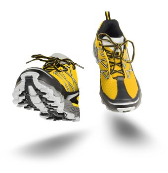 Yellow running sport shoes seen front, isolated on white background