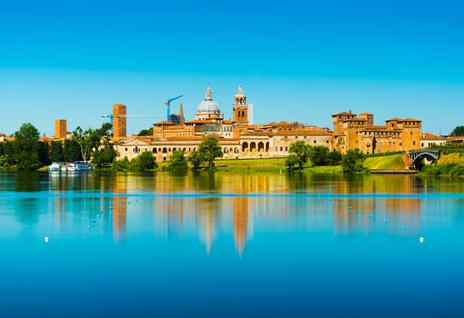 Mantova, Italy: Cityscape reflected in water. Old Italian town skyline. Province of Lombardy.