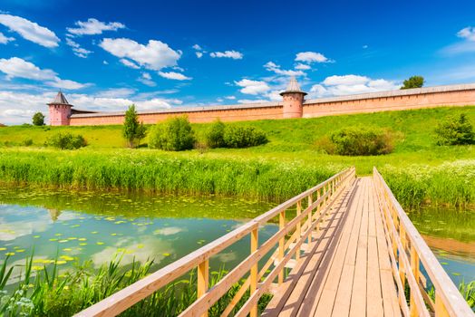 Wooden bridge across the river. Suzdal, the famous Russian town, part of The Golden Ring of Russia. Walled city, cityscape with old architecture