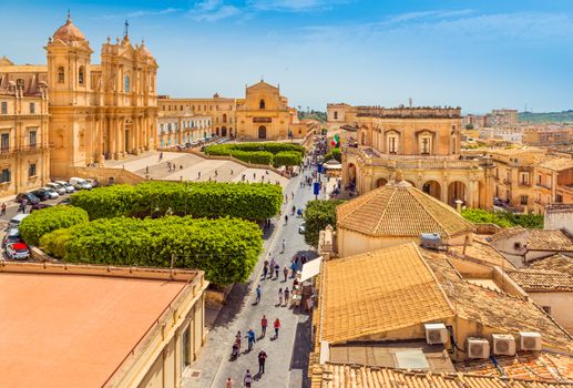 Cityscape of Noto. View of the central street with walking tourists. Province of Syracuse, Sicily, Italy