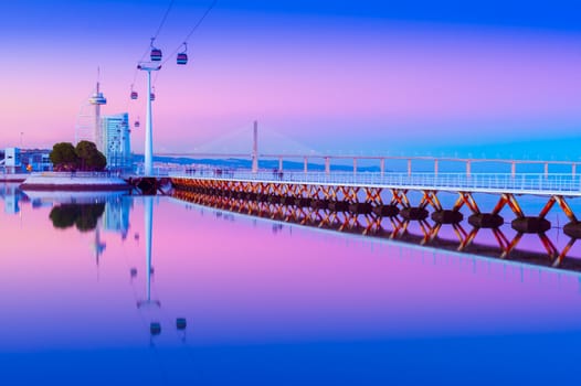 Evening cityscape of Lisbon mirrored in the water, Portugal. View of Park of the Nations (Parque das Nações) at dusk