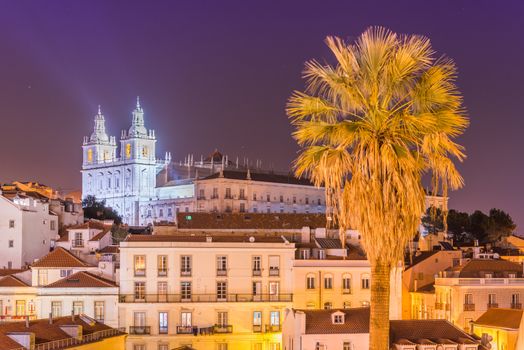 Lisbon cityscape, Alfama district at night. Facade of The Church of São Vicente of Fora (Monastery) illuminated by spotlights. Cultural Heritage of Portugal