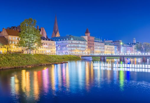 Night city view. Cityscape of Malmo in the evening, Sweden. Beautiful European town reflected in the water
