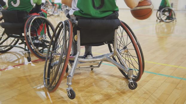 Disabled sportsmen plays wheelchair basketball, wide angle