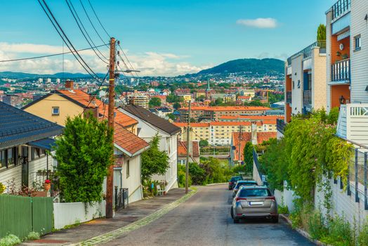 A street in Oslo, Norway. Beautiful view from a hill with old wooden houses to the city center with colorful architecture
