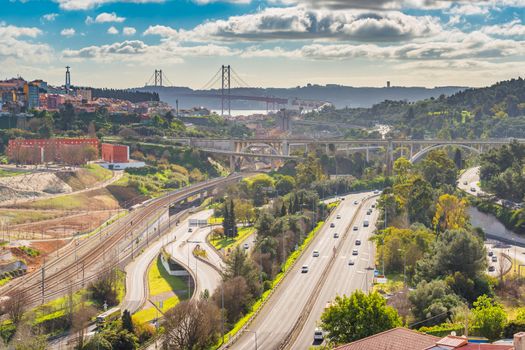 Aerial panorama of Lisbon with highways, overpasses and The 25th April Bridge (Ponte 25 de Abril), Portugal