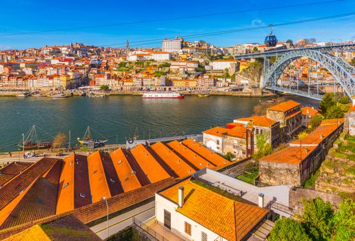 Cityscape of Porto with Dom Luis I Bridge, old architecture and cable car, Portugal