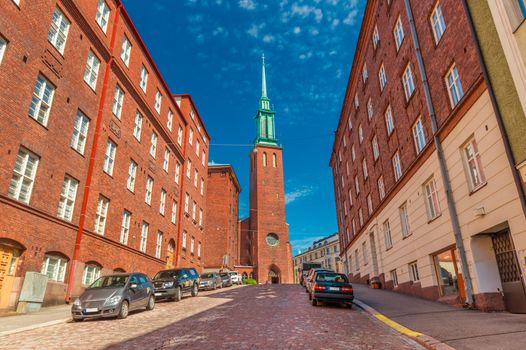 A street of Helsinki with the traditional architecture and a Church (Kristuskyrkan), in the Finnish neo-gothic style