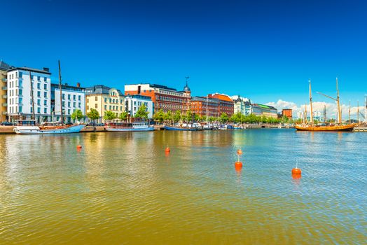 A beautiful view of Helsinki with historical buildings, harbor with boats and wooden old ship, Finland