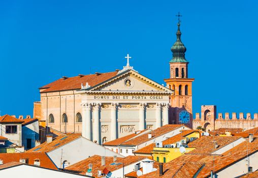 Cathedral in the walled Italian city of Cittadella, Italy. The text in Latin: The temple of the Gate and Heaven. Orange roof tiles as a part of traditional architecture style.