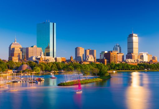 Boston skyline at the evening. Cityscape of Back Bay Boston. Skyscrapers and office buildings reflected in the water of Charles River.