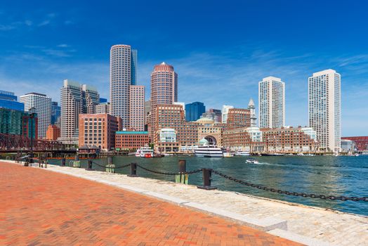 Boston skyline in summer day, skyscrapers in downtown against the blue sky, view from harbor, Massachusetts, USA