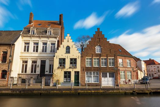 Bruges (Brugge) - February of 2016, Belgium: Old  belgian street with traditional varicolored  houses and water canal