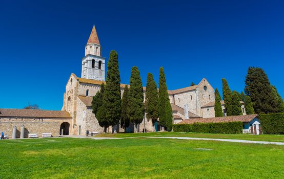 Aquileia - April 2016, Italy: Ancient Roman Сhurch in the city of Aquileia against the  clear blue sky (Basilica di Santa Maria Assunta)
