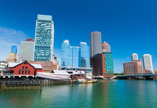 Boston - June 2016, MA, USA: Boston cityscape, Tea Party museum and modern buildings in downtown reflected in water
