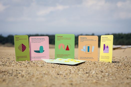 Arnhem, Netherlands, June 2020: Photography skill improvement cards game in the sand