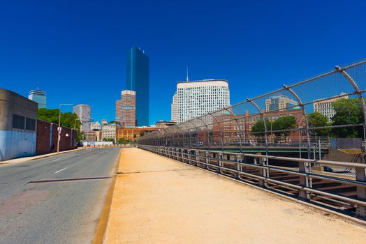 Boston - June 2016, MA, USA: View of commercial buildings in Boston downtown from the road with no traffic, cityscape against the clear blue sky