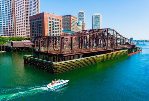 Boston - June 2016, MA, USA: Boat with people is floating on water from Boston harbor towards the open sea (ocean)