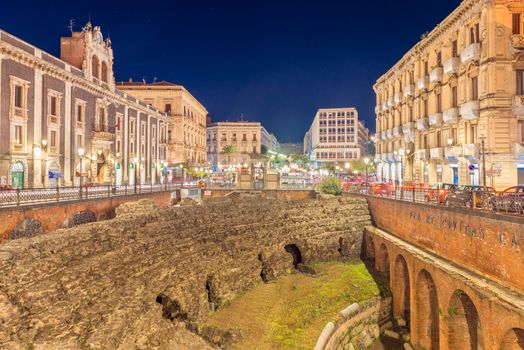 Catania - April 2019, Sicily, Italy: Evening view of The Roman Amphitheater in Catania. Ruins of an ancient theater