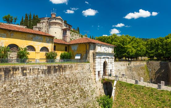 Brescia - July 2017, Lombardy, Italy: The Castle of Brescia and city gates with bridge