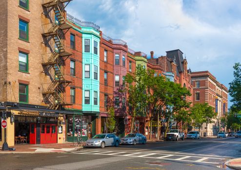 Boston - June 2016, USA: View of the typical street of Boston in Back Bay after the rain, old brick houses in traditional architecture style and cars parked near them