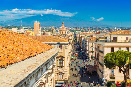 Catania - April 2019, Sicily, Italy: Panoramic view of the famous Sicilian city with The Mount Etna in the background. View of the central street Via Etnea