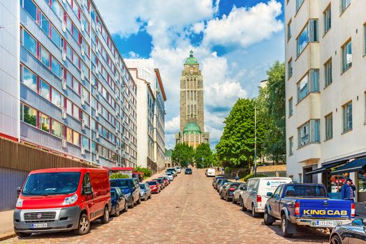 Helsinki - June 2019, Finland: View of the Kallio Church (Kallion kirkko) and a street with parked cars