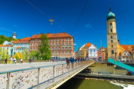 Graz - May 2017, Austria: View of the old city center on sunny day. Franciscan Church and the old historical buildings with orange roofs 