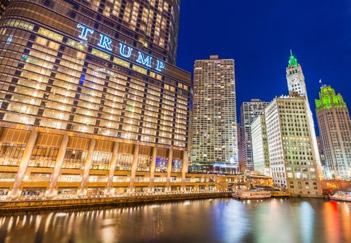 Chicago - March 2017, IL, USA: Downtown Chicago at night. View of Illuminated buildings in the central part of the city. Trump Tower and The Wrigley Building reflected in Chicago river