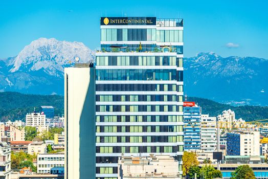 Ljubljana - September 2019, Slovenia: Stunning view of The Intercontinental hotel building with snowy mountains in the background. New build modern architecture