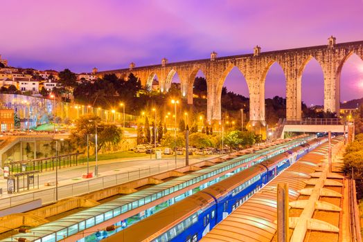 Lisbon - January 2019, Portugal: Evening view of the historic aqueduct in Lisbon (Aqueduto das Aguas Livres), Train station "Campolide"