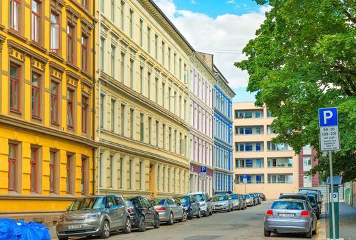 Oslo - June 2019, Norway: A street of Oslo with colorful historical architecture and cars parked along the street