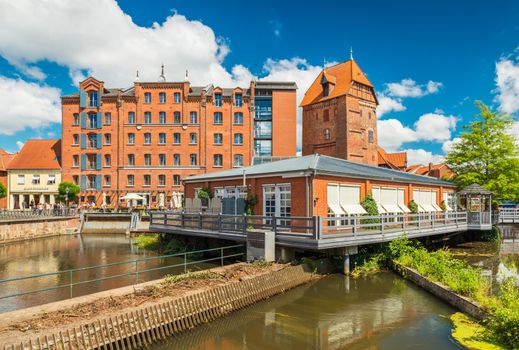 Luneburg - July 2018, Lower Saxony, Germany: Historical buildings and modern restaurant build on the water
