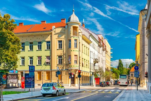 Ljubljana - September 2019, Slovenia: A street in the historical city center of Ljubljana. Old colorful buildings with blue sky in the background