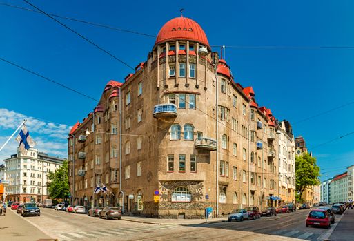 Helsinki - June 2019, Finland: A building in the historical part of Helsinki. View of a street with parked cars and an old building
