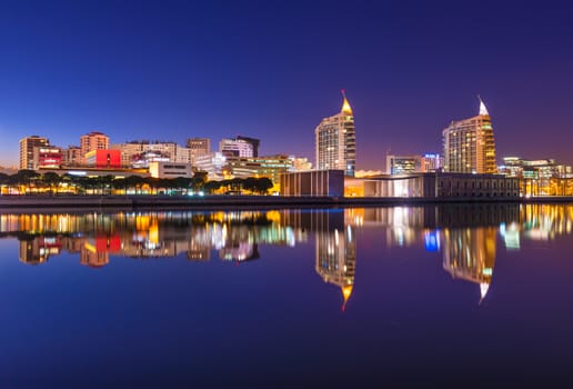 Lisbon - February 2019, Portugal: View of The Nations Park (Parque das Nações) in Lisbon. Modern cityscape mirrored in the water