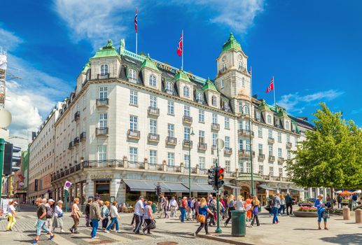 Oslo - June 2019, Norway: View of the Grand Hotel Oslo and people crossing the road near it