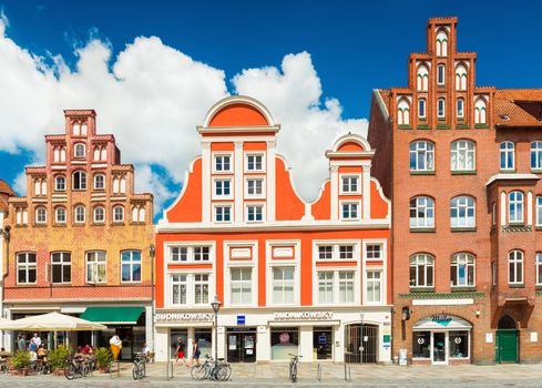Luneburg - July 2018, Germany: A street with houses in the traditional German architectural style. Colored buildings in old european town. Brick Gothic architecture